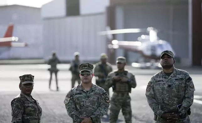 Security officers stand on the tarmac before Secretary of State Marco Rubio arrives to watch people board a repatriation flight bound for Colombia at Albrook Airport in Panama City, Monday, Feb. 3, 2025. (AP Photo/Mark Schiefelbein, Pool)