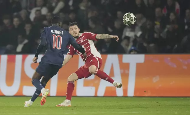 Brest's Mathias Pereira Lage, right, looks on the ball next to PSG's Ousmane Dembele during the Champions League playoff second leg soccer match between Paris Saint-Germain and Brest at the Parc des Princes in Paris, Wednesday, Feb. 19, 2025. (AP Photo/Michel Euler)