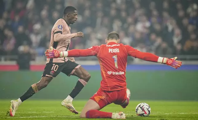Lyon's goalkeeper Lucas Perri, right, makes a save in front of PSG's Ousmane Dembele during the French League One soccer match between Lyon and Paris Saint-Germain at the Groupama stadium, outside Lyon, France, Sunday, Feb. 23, 2025. (AP Photo/Laurent Cipriani)