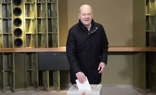 German Chancellor Olaf Scholz casts his vote at a polling station in Berlin, Germany, Sunday, Feb. 23, 2025, during the German national election. (AP Photo/Ebrahim Noroozi)