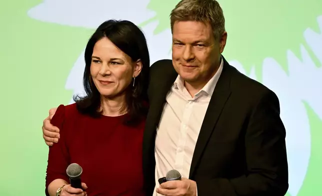German Foreign Minister Annalena Baerbock, left, and the top candidate Robert Habeck attend the election party of the Greens (Buendnis 90/Die Gruenen) in Berlin Germany, Sunday, Feb. 23, 2025.(Fabian Sommer/dpa via AP)
