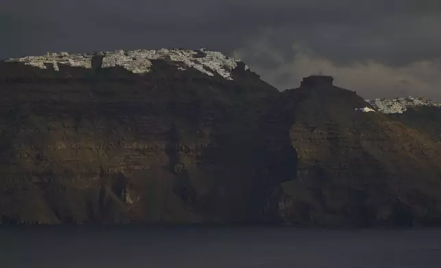 The main town of Fira is seen from across a bay on the earthquake-struck island of Santorini, Greece, Tuesday, Feb. 4, 2025. (AP Photo/Petros Giannakouris)