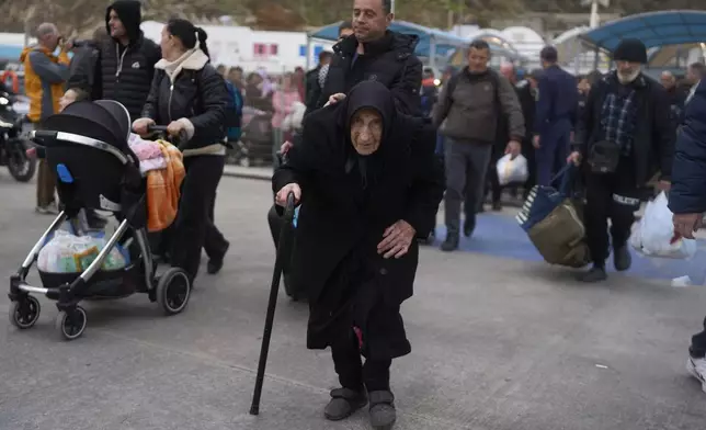 Flora, 94, said she survived a deadly earthquake on Santorini in 1956, as she boards a ferry bound for the Greek mainland, in the earthquake-struck Greek island, Tuesday, Feb. 4, 2025. (AP Photo/Petros Giannakouris)