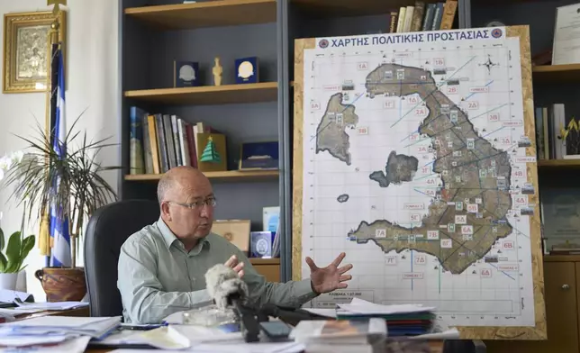 Santorini Mayor Nikos Zorzos speaks with the Associated Press moments before an earthquake that occurred during the interviewing in the Aegean Sea island of Santorini, Greece, Tuesday, Feb. 4, 2025. (AP Photo/Petros Giannakouris)