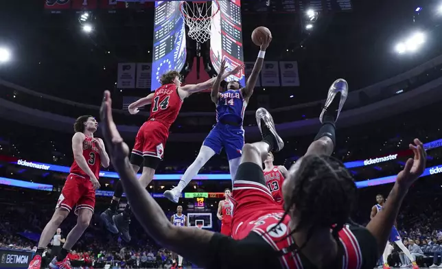 Philadelphia 76ers' Ricky Council IV, right, goes up for a shot against Chicago Bulls' Matas Buzelis during the second half of an NBA basketball game Monday, Feb. 24, 2025, in Philadelphia. (AP Photo/Matt Slocum)