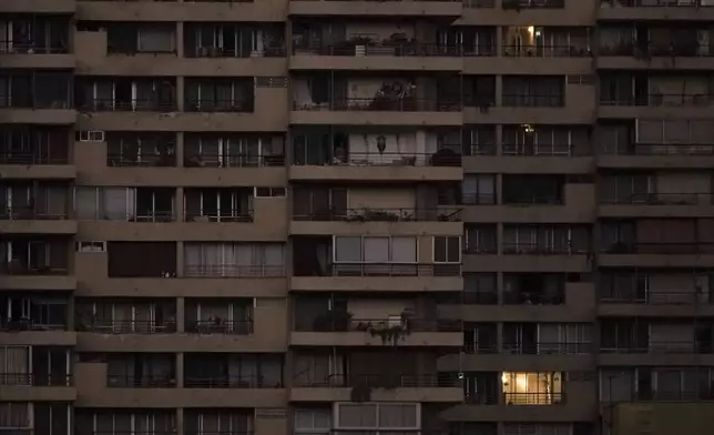 An apartment is illuminated the morning after power was restored from a nationwide blackout in Santiago, Chile, Wednesday, Feb. 26, 2025. (AP Photo/Matias Basualdo)