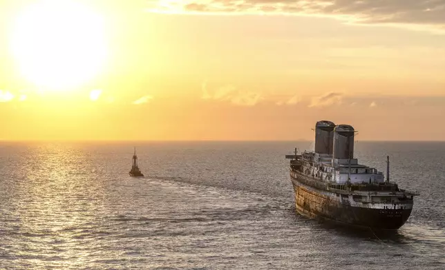 The SS United States is towed at sunset past Key West, Fla., headed to Mobile, Ala., Thursday, Feb. 27, 2025, where it will be prepared to be used as an artificial reef. (Rob O'Neal/The Key West Citizen via AP)