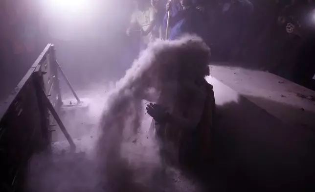 A Hindu holy man bathes with ash at crematorium in Jhulasan village of Mehsana district of Gujarat state on Shivratri festival, India, Wednesday, Feb. 26, 2025. (AP Photo/Ajit Solanki)