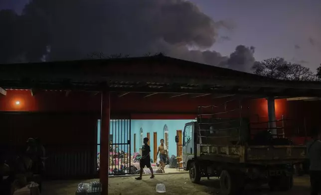Migrants spend the night in a shelter in Palenque, Panama, Wednesday, Feb. 26, 2025. The migrants are returning from southern Mexico after giving up on reaching the U.S., a reverse flow triggered by the Trump administration's immigration crackdown. (AP Photo/Matias Delacroix)