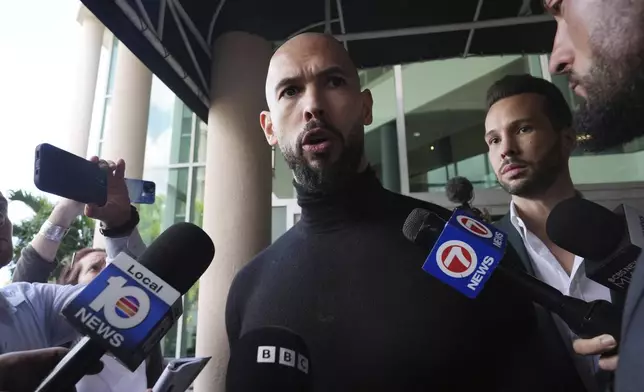 Influencer brothers Andrew and Tristan Tate arrive, Thursday, Feb. 27, 2025, in Fort Lauderdale, Fla. The brothers were charged with human trafficking in Romania and arrived in the U.S. after authorities lifted travel restrictions. (AP Photo/Marta Lavandier)