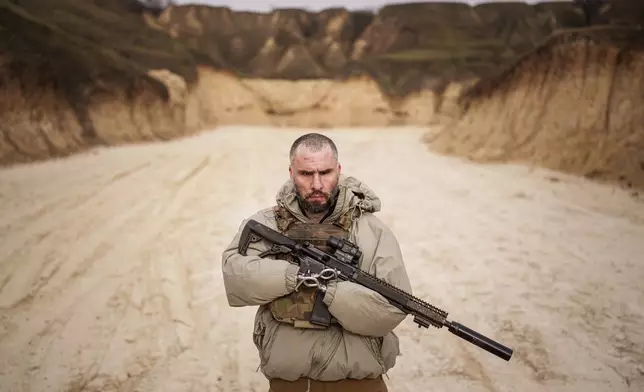 Andrii Rubliuk, a senior sergeant with a Ukrainian intelligence unit who lost both arms and a leg in combat, holds a rifle during military training near Kyiv, Ukraine, on Feb. 14, 2025. (AP Photo/Evgeniy Maloletka)
