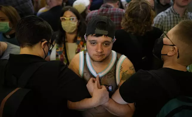 Protesters fill the Iowa state Capitol to denounce a bill that would strip the state civil rights code of protections based on gender identity, Thursday, Feb. 27, 2025, in Des Moines, Iowa. (AP Photo/Charlie Neibergall)