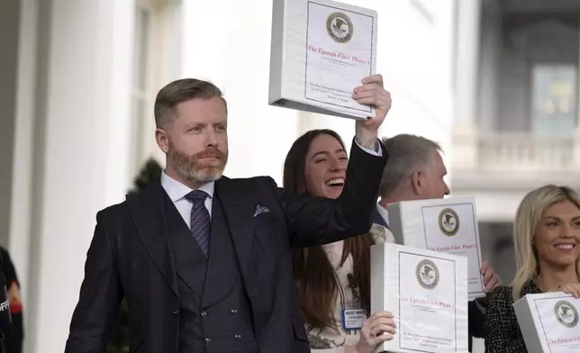 Conservative political commentator Rogan O'Handley, also known as DC Draino, from left, and social media content creator Chaya Raichik hold up binders with a cover titled "The Epstein Files: Phase 1" at the White House, Thursday, Feb. 27, 2025, in Washington. (AP Photo/Evan Vucci)