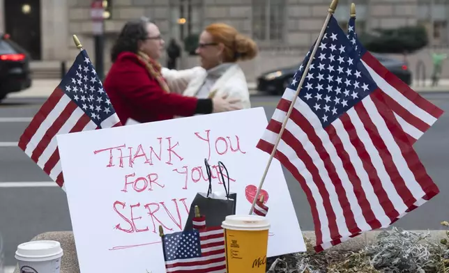 Flags and a sign thanking United States Agency for International Development (USAID) workers are pictured as USAID workers retrieve their personal belongings from USAID's headquarters in Washington, Thursday, Feb. 27, 2025, in Washington. (AP Photo/Manuel Balce Ceneta)