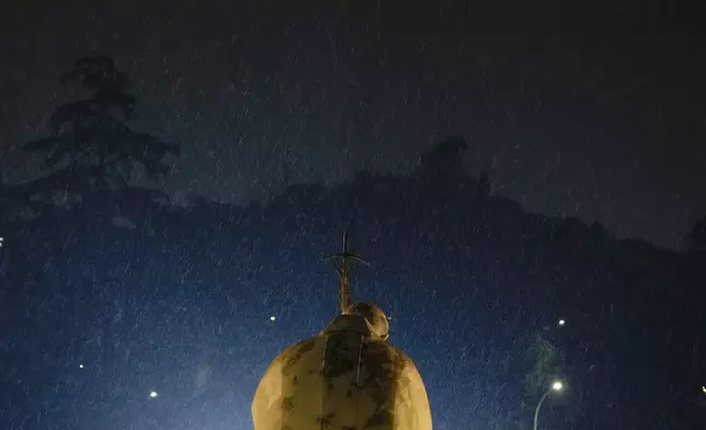 Rain falls over Pope John Paul II statue outside the Agostino Gemelli Polyclinic where Pope Francis is hospitalised in Rome, Monday, Feb. 24, 2025. (AP Photo/Gregorio Borgia)