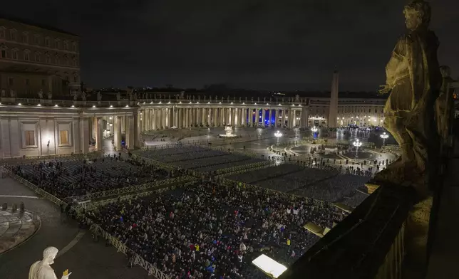 CORRECTS DAY Catholic faithful attend a nightly rosary prayer service for the health of Pope Francis in St. Peter's Square at the Vatican, Tuesday, Feb. 25, 2025. (AP Photo/Bernat Armangue)