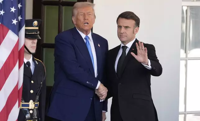 President Donald Trump speaks as he greets France's President Emmanuel Macron, right, before a news conference at the White House, Monday, Feb. 24, 2025, in Washington. (AP Photo/Manuel Balce Ceneta)