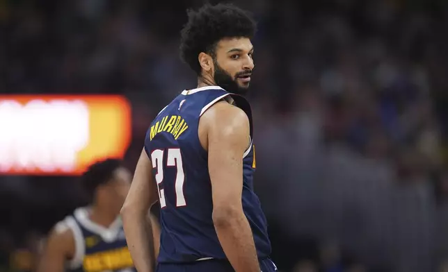 Denver Nuggets guard Jamal Murray looks back at the Portland Trail Blazers bench after hitting a 3-point basket in the second half of an NBA basketball game Wednesday, Feb. 12, 2025, in Denver. (AP Photo/David Zalubowski)