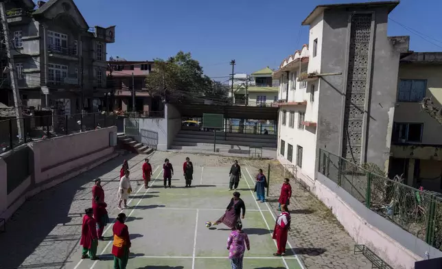 Women play football during a break at the Ujyalo Community learning center in Kathmandu, Nepal, Feb. 6, 2025. (AP Photo/Niranjan Shrestha)