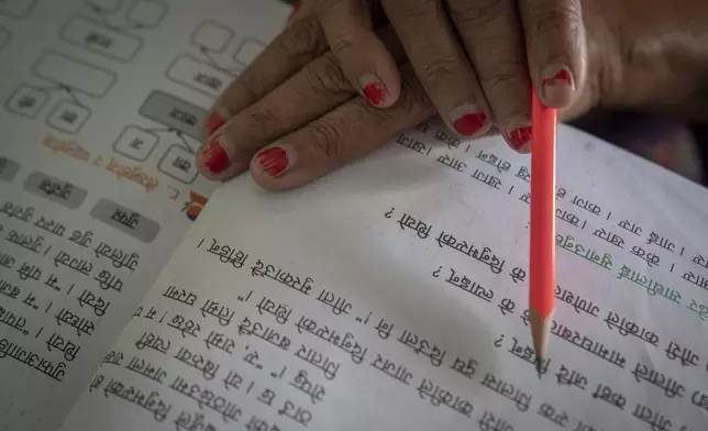 An elderly woman attends a class at the Ujyalo Community learning center in Kathmandu, Nepal, Feb. 6, 2025. (AP Photo/Niranjan Shrestha)