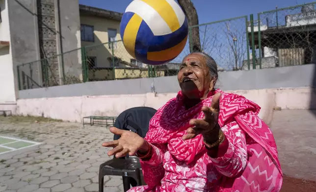 Chandra Kumari Ghimire, 71 plays during a break at the Ujyalo Community learning center in Kathmandu, Nepal, Feb. 6, 2025. (AP Photo/Niranjan Shrestha)