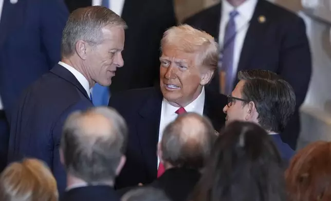 President Donald Trump talks to Senate Majority Leader John Thune, R-S.D., left and and House Speaker Mike Johnson, R-La., right, after he spoke to the National Prayer Breakfast, at the Capitol in Washington, Thursday, Feb. 6, 2025. (AP Photo/J. Scott Applewhite)