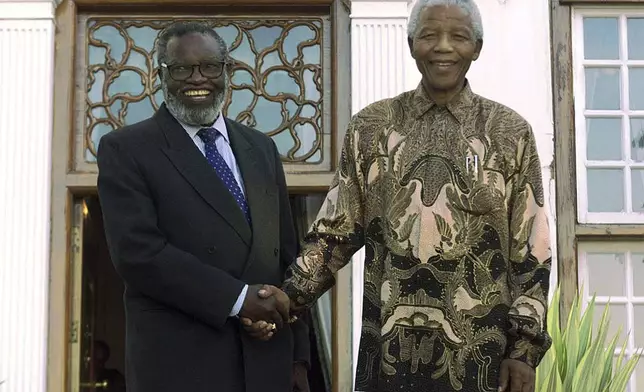 FILE - South African President Nelson Mandela, right, shakes hands with Namibian President Sam Nujoma at the presidential residence in Pretoria, South Africa, June 1, 1999, on the eve of the country's second all-race elections. (AP Photo/Jean-Marc Bouju, File)