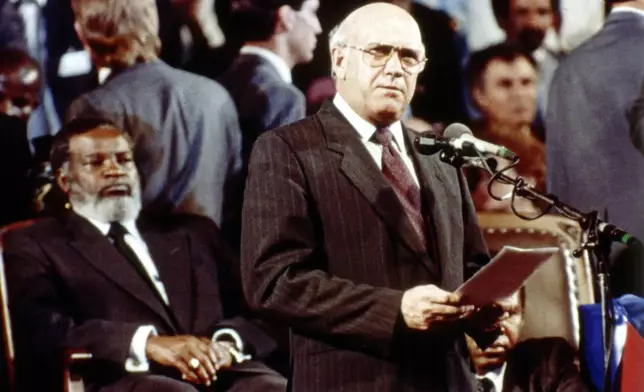 FILE - South African President F.W. de Klerk delivers his speech in Windhoek, Namibia, March 21, 1990, where he handed over Namibia to Namibian President Sam Nujoma, seated left, during an independence ceremony. (AP Photo/John Parkin, File)