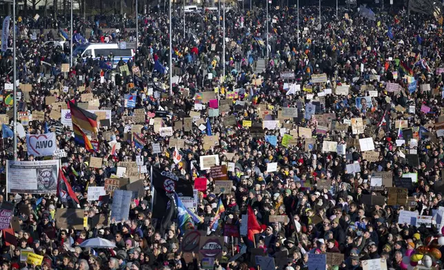 People gather to take part in a rally against right-wing extremism, in Munich, Germany, Saturday Feb. 8, 2025. (Sven Hoppe/dpa via AP)