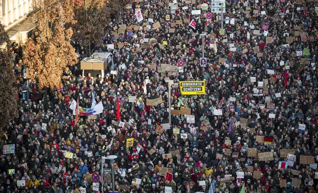 People gather to take part in the demonstration against right-wing extremism, in Nuremberg, Germany, Saturday Feb. 8, 2025. (Daniel Vogl/dpa via AP)