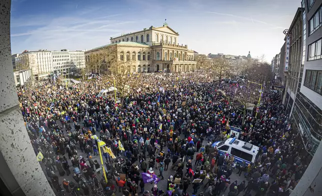 People gather to take part in the demonstration against right-wing extremism, in Hanover, Germany, Saturday Feb. 8, 2025. (Moritz Frankenberg/dpa via AP)