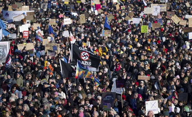Numerous people take part in a rally against right-wing extremism on the Theresienwiese in Munich, Germany, Sunday, Feb. 8, 2025, as a broad alliance of organizations (M'nchen ist bunt) has called for the demonstration under the motto "Democracy needs you". (Sven Hoppe/dpa via AP)