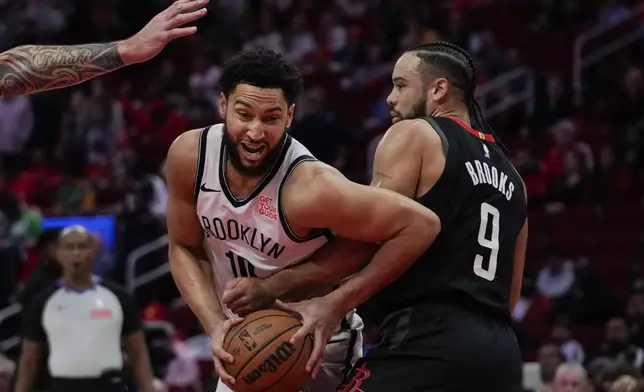 Houston Rockets forward Dillon Brooks (9) defends against Brooklyn Nets guard Ben Simmons (10) during the first half of an NBA basketball game in Houston, Saturday, Feb. 1, 2025. (AP Photo/Ashley Landis)