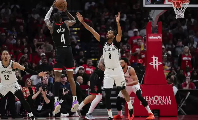 Houston Rockets guard Jalen Green (4) shoots against Brooklyn Nets forward Ziaire Williams (8) during the first half of an NBA basketball game in Houston, Saturday, Feb. 1, 2025. (AP Photo/Ashley Landis)