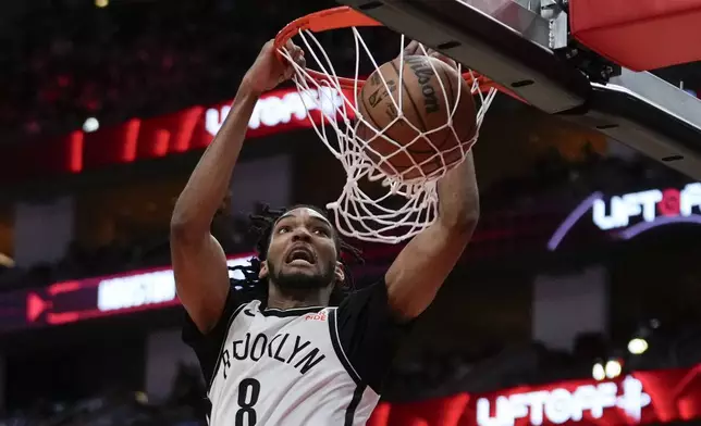 Brooklyn Nets forward Ziaire Williams (8) dunks during the first half of an NBA basketball game against the Houston Rockets in Houston, Saturday, Feb. 1, 2025. (AP Photo/Ashley Landis)