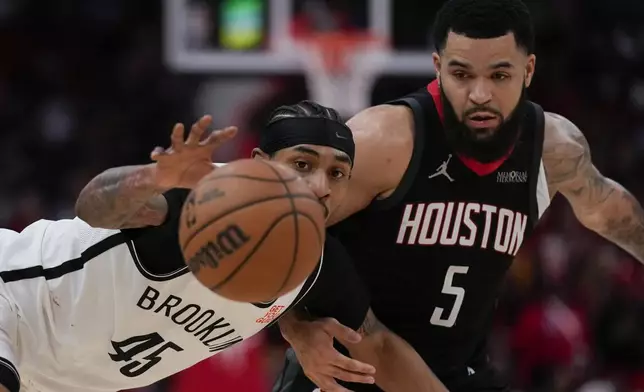 Brooklyn Nets guard Keon Johnson (45) reaches for a loose ball while defended by Houston Rockets guard Fred VanVleet (5) during the first half of an NBA basketball game in Houston, Saturday, Feb. 1, 2025. (AP Photo/Ashley Landis)