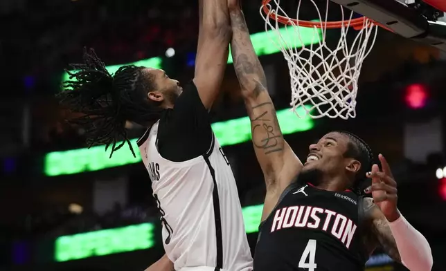 Brooklyn Nets forward Ziaire Williams (8) shoots against Houston Rockets guard Jalen Green (4) during the first half of an NBA basketball game in Houston, Saturday, Feb. 1, 2025. (AP Photo/Ashley Landis)