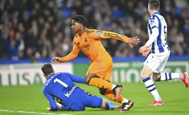 Real Madrid's Endrick, centre, scores his side's opening goal during the Spanish Copa del Rey soccer match between Real Sociedad and Real Madrid at the Reale Arena in San Sebastian, Spain, Wednesday, Feb. 26, 2025. (AP Photo/Miguel Oses)