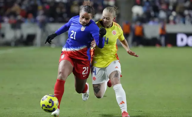 United States forward Michelle Cooper (21) moves the ball in front of Colombia defender Ana Guzman (4) during the SheBelieves Cup women's soccer tournament, Thursday, Feb. 20, 2025, in Houston. (AP Photo/Michael Wyke)