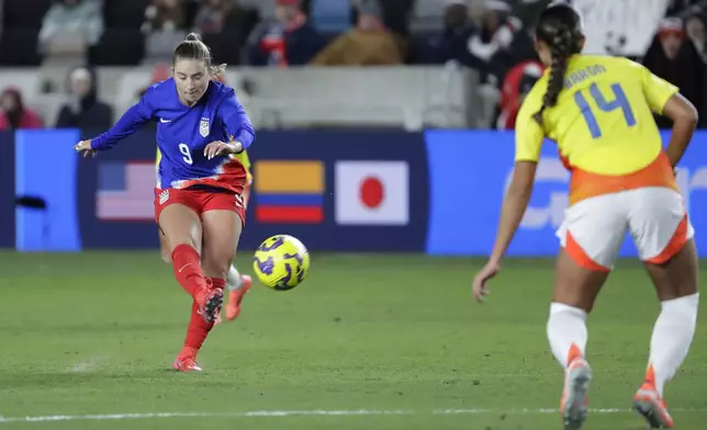 United States forward Ally Sentnor (9) gets her scoring goal kick past Colombia defender Angela Baron (14) during the SheBelieves Cup women's soccer tournament, Thursday, Feb. 20, 2025, in Houston. (AP Photo/Michael Wyke)