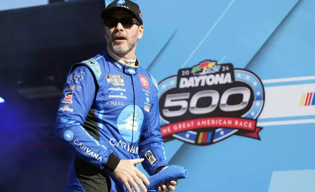 FILE - Jimmie Johnson walks out during driver introductions for the NASCAR Daytona 500 auto race at Daytona International Speedway, Feb. 19, 2024, in Daytona Beach, Fla. (AP Photo/John Raoux, file)