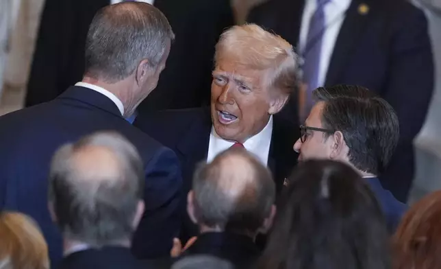 President Donald Trump talks to Senate Majority Leader John Thune, R-S.D., left and and House Speaker Mike Johnson, R-La., right, after he spoke to the National Prayer Breakfast, at the Capitol in Washington, Thursday, Feb. 6, 2025. (AP Photo/J. Scott Applewhite)