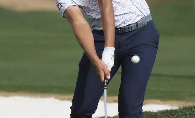 Christiaan Bezuidenhout, of South Africa, hits his approach shot on the second hole during the final round of the Phoenix Open golf tournament at TPC Scottsdale, Sunday, Feb. 9, 2025, in Scottsdale, Ariz. (AP Photo/Ross D. Franklin)