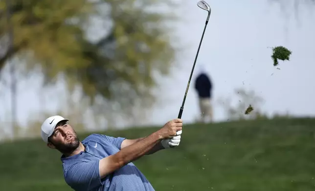 Scottie Scheffler hits his approach shot at the second hole during the final round of the Phoenix Open golf tournament at TPC Scottsdale Sunday, Feb. 9, 2025, in Scottsdale, Ariz. (AP Photo/Ross D. Franklin)