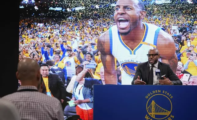 Former basketball player Andre Iguodala, right, talks to reporters before an NBA basketball game between the Golden State Warriors and the Dallas Mavericks, Sunday, Feb. 23, 2025, in San Francisco. (AP Photo/Godofredo A. Vásquez)