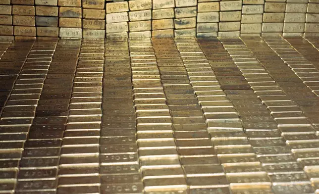FILE - Gold bars are stored at the U.S. Depository in Ft. Knox, Kentucky, Sept. 24, 1974. (AP Photo/Barry Thumma, File)