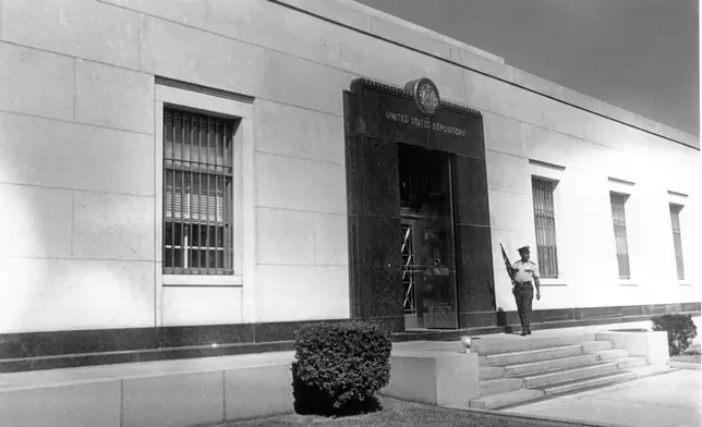 FILE - An armed officer stands guard outside the United States Depository for gold reserves, as the Director of the Mint gives members of Congress a tour in Fort Knox, Kentucky, Sept. 24, 1974. (AP Photo, File)