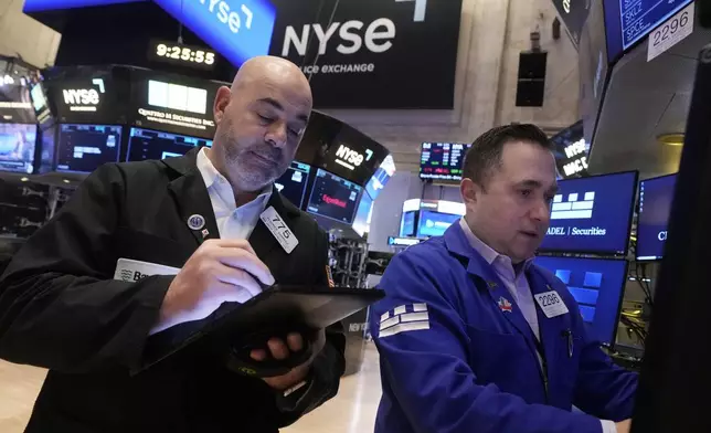 Trader Fred Demarco, left, and specialist Genaro Saporito work the floor of the New York Stock Exchange, Tuesday, Feb. 4, 2025. (AP Photo/Richard Drew)