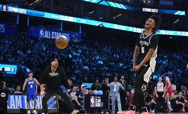 San Antonio Spurs guard Stephon Castle reacts after dunking during the slam dunk contest at the NBA basketball All-Star Saturday night festivities Saturday, Feb. 15, 2025, in San Francisco. (AP Photo/Godofredo A. Vásquez)