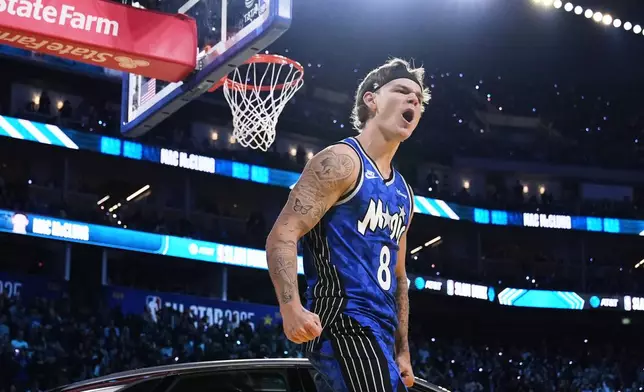 Orlando Magic guard Mac McClung celebrates after dunking over a car during the slam dunk contest at the NBA basketball All-Star Saturday night festivities Saturday, Feb. 15, 2025, in San Francisco. (AP Photo/Godofredo A. Vásquez)